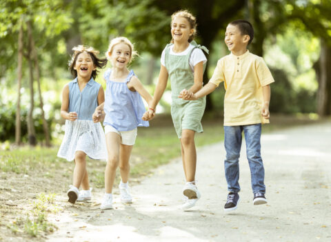 Group of asian and caucasian kids having fun in the park